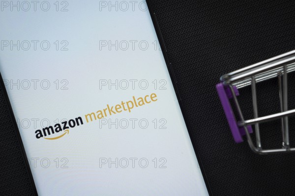 Dhaka, Bangladesh- 21 Nov 2025: A smartphone displaying the amazon marketplace logo next to a