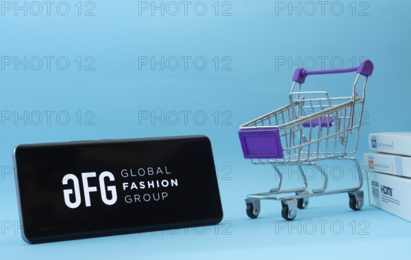 Dhaka, Bangladesh- 21 Nov 2025: Smartphone with Global Fashion Group logo next to a small shopping