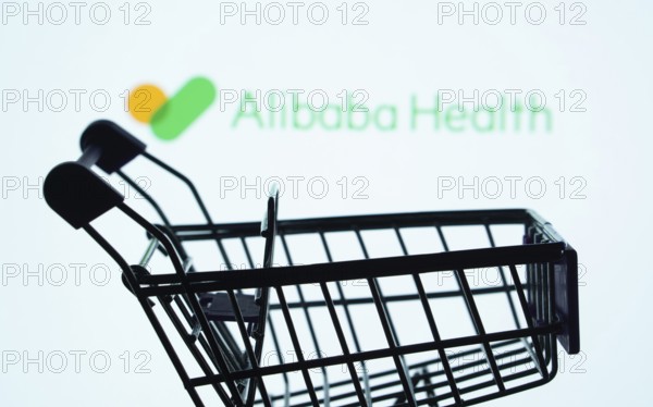 Dhaka, Bangladesh- 21 Nov 2025: Silhouette of a shopping cart in front of the Alibaba Health logo,