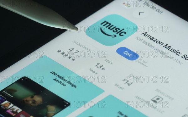 Dhaka, Bangladesh- 21 Nov 2025: Amazon Music app on a iPad screen with a pen pointing at the