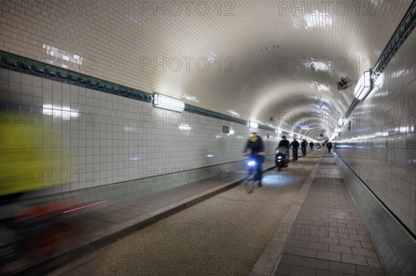 Interior view, pedestrians and cyclists crossing tunnel, mopping effect, movement, tube, historic