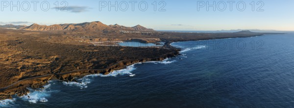 Coast with lava fields, volcanic landscape near Los Hervideros, in the evening light, aerial view,
