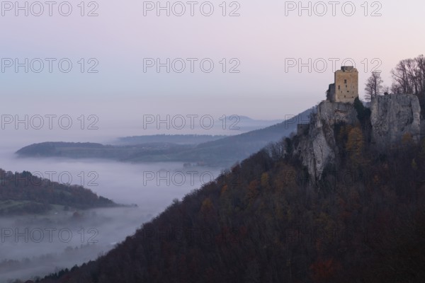 Sunrise with fog in the Neidlinger Valley with a view of the Reussenstein castle ruins. Swabian