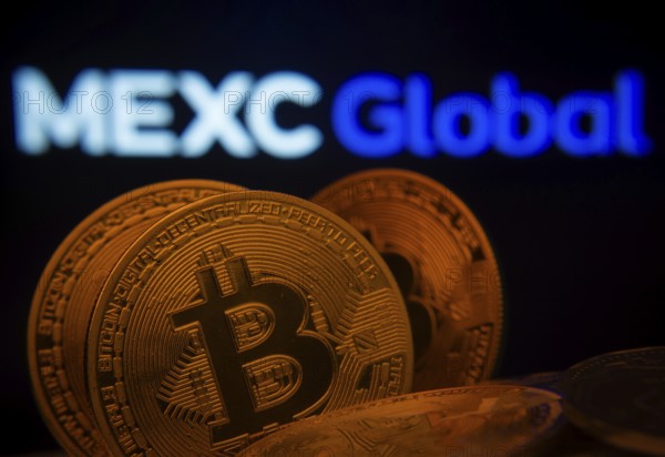 Dhaka, Bangladesh- 03 Sep 2025: Close-up of Bitcoin coins with the MEXC Global logo visible on a