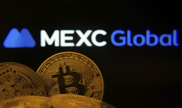 Dhaka, Bangladesh- 03 Sep 2025: Close-up of Bitcoin coins with the MEXC Global logo visible on a
