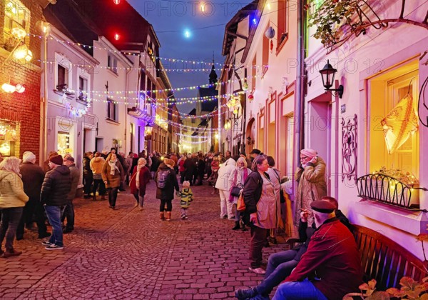 People in the Tiefstraße decorated for the Martin train in the evening, historic old town, Kempen,