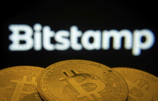 Dhaka, Bangladesh- 03 Sep 2025: Close-up of Bitcoin coins with the Bitstamp logo visible on a