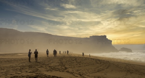 Tourists watch the waves of the Atlantic on the rocky plateau of Sito, also known as Forte São