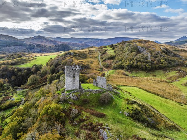 Autumn colours over Castell Dolwyddelan and Eryri Mountains from a drone, Snowdonia, Conwy County
