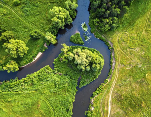 Ecology and environment concept. Green wilderness nature from above. Aerial view on meandering