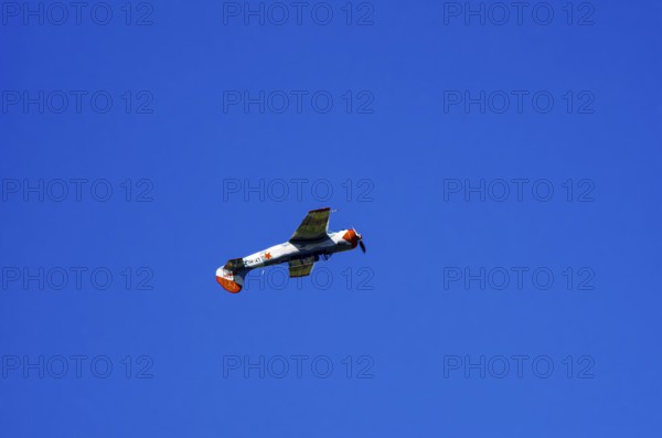 A Jakovlev Jak-52 with registration LY-HLZ during a flight demonstration as part of an air show on