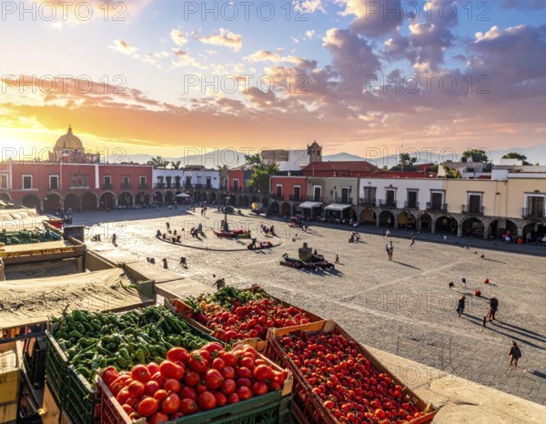 Traditional Mexican plaza with crates of peppers, onions, and tomatoes, economic prosperity in