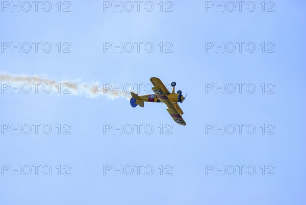 A Boeing-Stearman biplane during a flight demonstration as part of an air show at the Rossfeld in