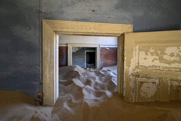 Sand mountains in a former dwelling house, interior photograph, Kolmanskop, restricted diamond