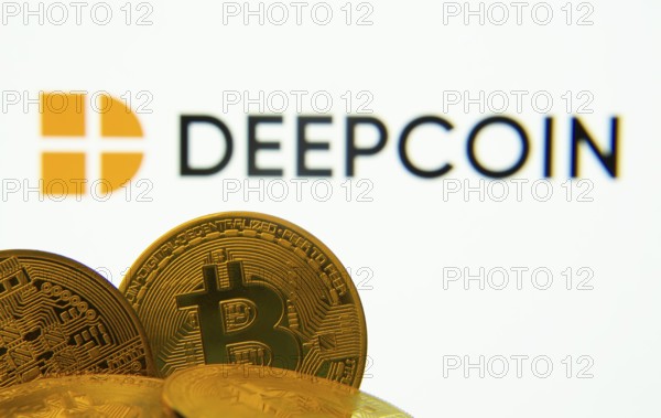Dhaka, Bangladesh- 03 Oct 2025: Close-up of Bitcoin coins with the Deepcoin logo visible on a