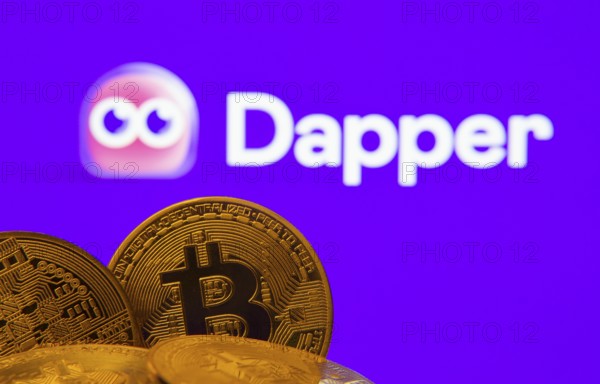 Dhaka, Bangladesh- 03 Oct 2025: Close-up of Bitcoin coins with the Dapper logo visible on a screen