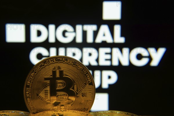 Dhaka, Bangladesh- 03 Oct 2025: Close-up of Bitcoin coins with the Digital currency group logo