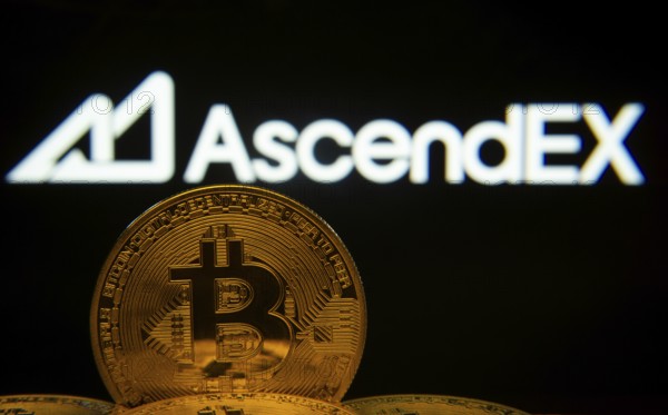 Dhaka, Bangladesh- 02 June 2025: Close-up of Bitcoin coins with the AscendEX logo visible on a