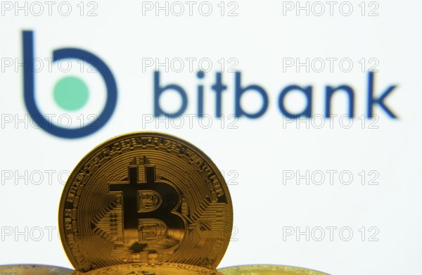Dhaka, Bangladesh- 02 June 2025: Close-up of Bitcoin coins with the bitbank logo visible on a
