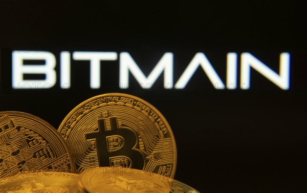 Dhaka, Bangladesh- 15 June 2025: Close-up of Bitcoin coins with the Bitmain logo visible on a