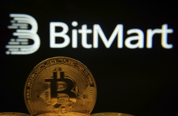 Dhaka, Bangladesh- 03 Sep 2025: Close-up of Bitcoin coins with the Bitmart logo visible on a screen