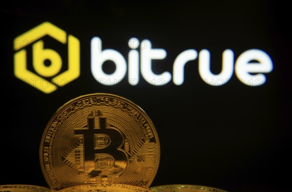 Dhaka, Bangladesh- 03 Sep 2025: Close-up of Bitcoin coins with the Bitrue logo visible on a screen