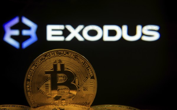 Dhaka, Bangladesh- 06 Sep 2025: Close-up of Bitcoin coins with the Exodus logo visible on a screen