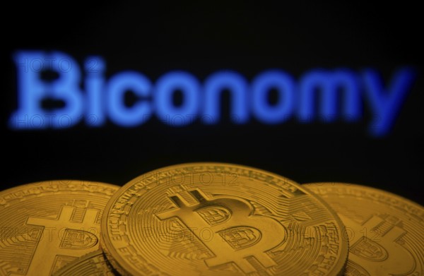 Dhaka, Bangladesh- 02 June 2025: Close-up of Bitcoin coins with the Biconomy logo visible on a
