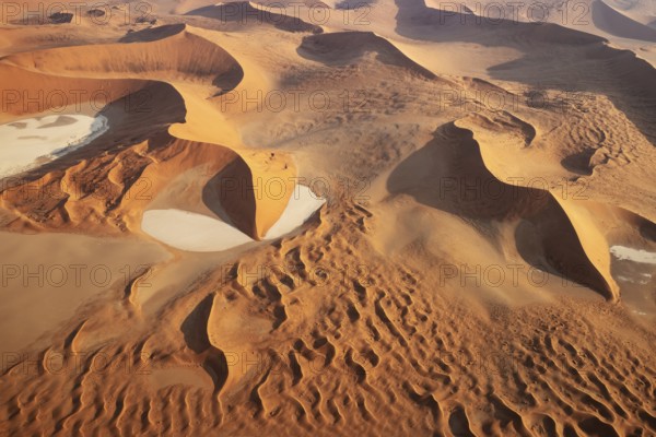 Sand dunes and dry pans in the Namib Desert. In the evening. Aerial view. Namib-Naukluft Park,