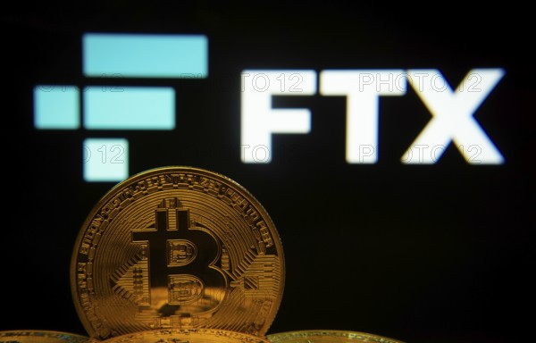 Dhaka, Bangladesh- 03 Sep 2025: Close-up of Bitcoin coins with the FTX logo visible on a screen in