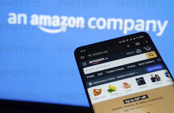 Dhaka, Bangladesh- 03 July 2025: Smartphone displaying Amazon web interface against Amazon logo