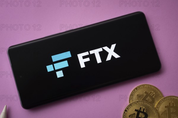 Dhaka, Bangladesh- 03 Saep 2025: FTX logo on smartphone screen near Bitcoin coin and QR code on