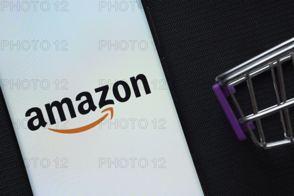 Dhaka, Bangladesh- 03 July 2025: A smartphone displaying the Amazon logo next to a miniature