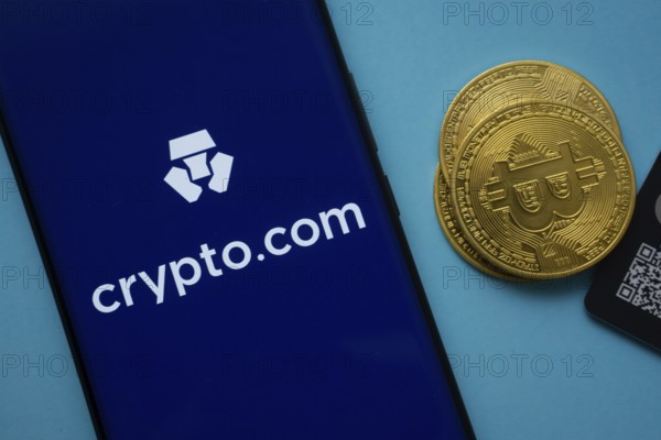 Dhaka, Bangladesh- 26 Aug 2025: Crypto.com logo on smartphone screen near Bitcoin coin and QR code