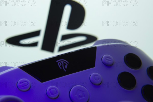 Dhaka, Bangladesh- 15 Aug 2025: A close-up of a gamepad with the PlayStation seen on screen in the