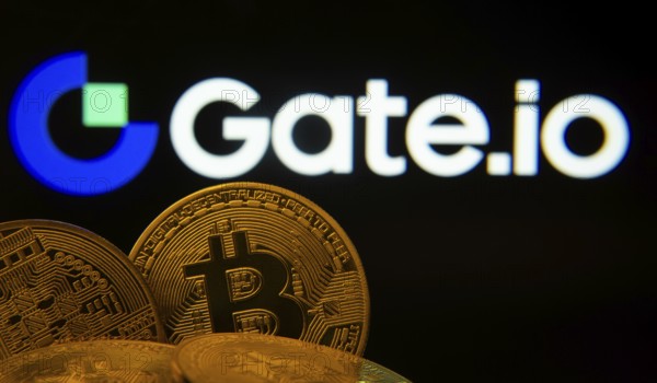 Dhaka, Bangladesh- 08 Aug 2025: Close-up of Bitcoin coins with the Gate.io logo visible on a screen