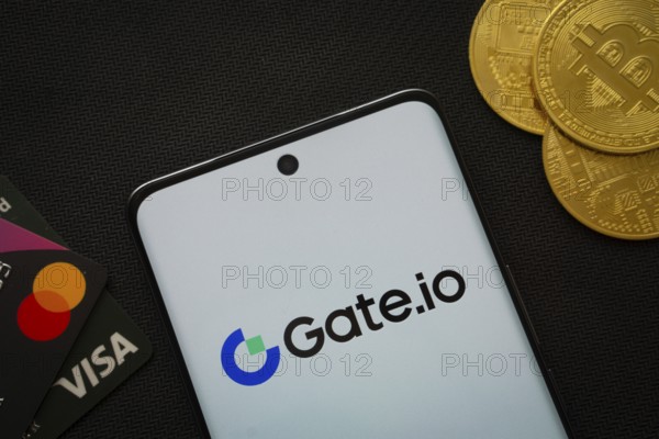 Dhaka, Bangladesh- 27 July 2025: Smartphone displaying Gate.io logo surrounded by Bitcoin coins and