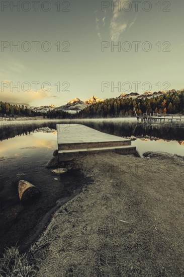 Lake Staz near Sankt Moritz in the Engadin in Switzerland. Morning atmosphere with fog in autumn.