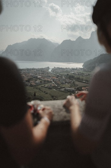 Young man taking a coffee break while riding his racing bike on Lake Garda. Sunny weather and dolce