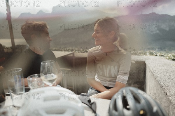 Young man taking a coffee break while riding his racing bike on Lake Garda. Sunny weather and dolce