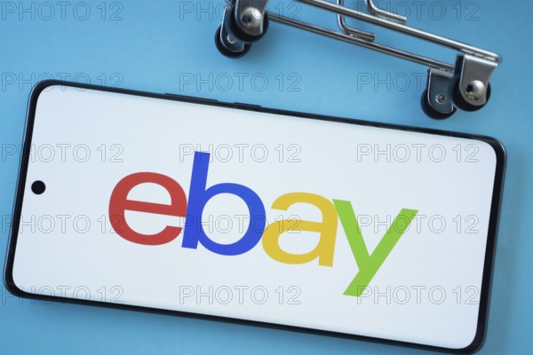 Dhaka, Bangladesh- 03 July 2025: Smartphone screen showing the eBay logo with shopping cart wheels