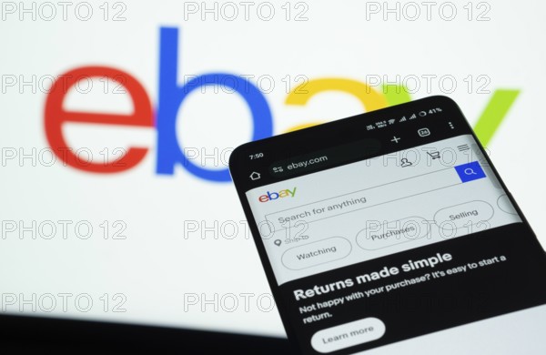 Dhaka, Bangladesh- 03 July 2025: Smartphone displaying eBay web interface against eBay logo