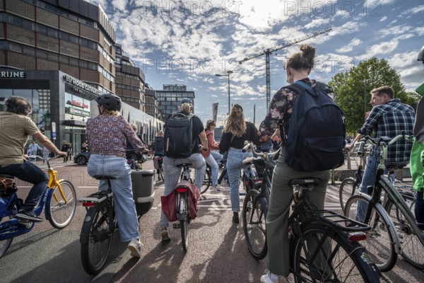 Ride your bike on the central cycle path on Lange Viestraat, Vredenburg, in the city centre of
