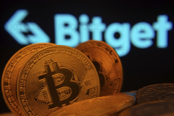 Dhaka, Bangladesh- 27 July 2025: Close-up of Bitcoin coins with the Bitget logo visible on a screen