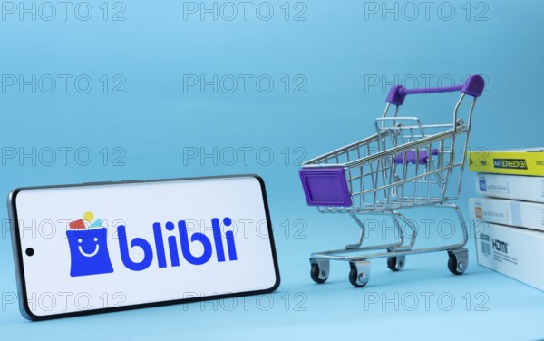 Dhaka, Bangladesh- 03 July 2025: Smartphone with Blibli logo next to a small shopping cart and