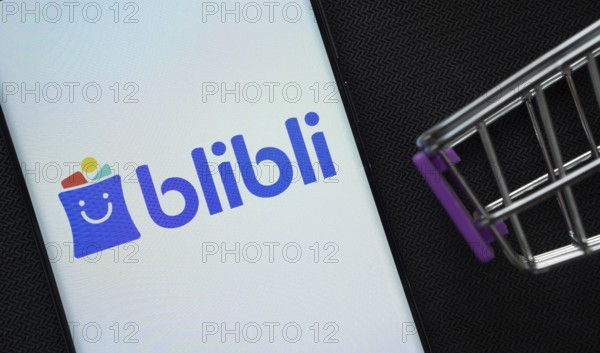 Dhaka, Bangladesh- 03 July 2025: A smartphone displaying the Blibli logo next to a miniature