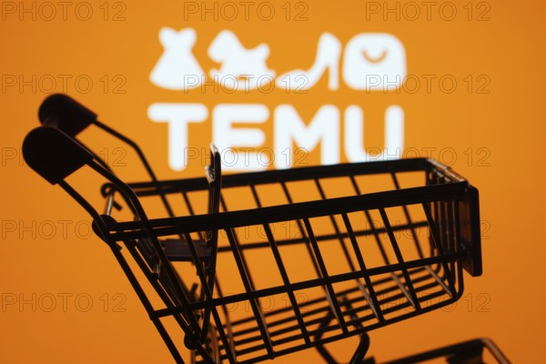 Dhaka, Bangladesh- 03 July 2025: Silhouette of a shopping cart in front of the Temu logo,