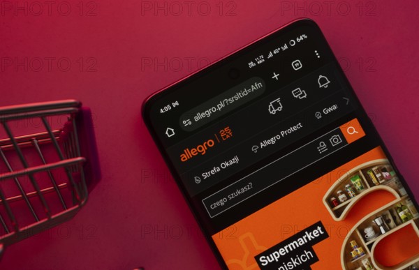 Dhaka, Bangladesh- 23 June 2025: A smartphone displaying the Allegro website with a shopping cart