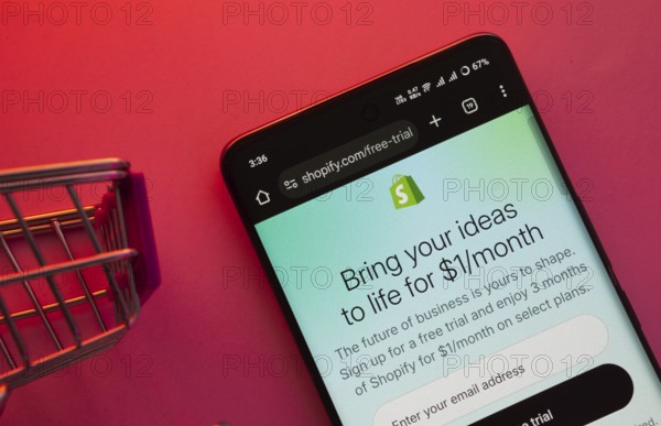 Dhaka, Bangladesh- 23 June 2025: A smartphone displaying the Shopify website with a shopping cart