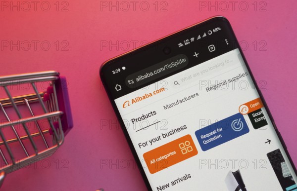 Dhaka, Bangladesh- 23 June 2025: A smartphone displaying the Alibaba website with a shopping cart